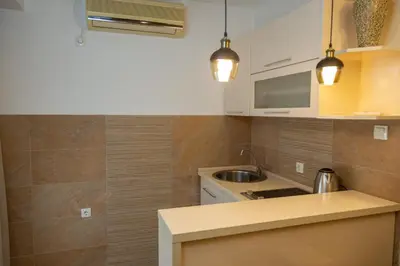 a kitchen with white cabinets and a counter top at Apartments Milla in Ulcinj