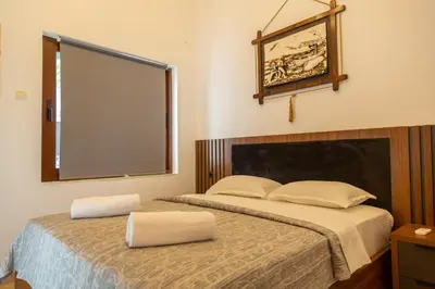 a bedroom with two beds and a large window at Apartments Milla in Ulcinj