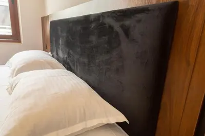 a bedroom with two beds and a black wall at Apartments Milla in Ulcinj