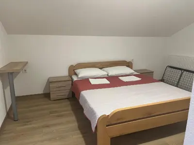 a small bedroom with a bed and a desk at SeaAdrik in Bar