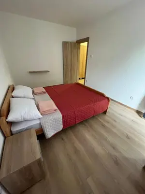 a bedroom with a large bed with a red blanket at SeaAdrik in Bar