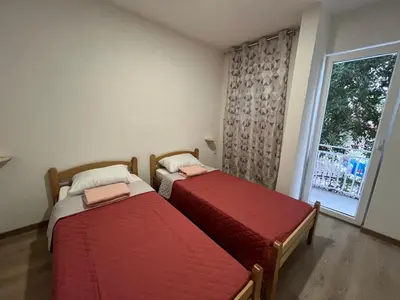 two beds in a room with a window at SeaAdrik in Bar