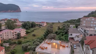 an aerial view of a city with the ocean at Apartments Bonazza in Petrovac na Moru
