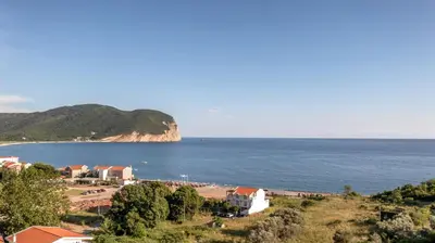 a view of a beach and the ocean at Apartments Bonazza in Petrovac na Moru