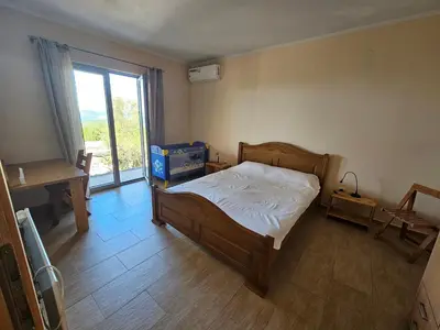 a bedroom with a bed and a window at Cadre exceptionnel Calme , Nature, Confort in Glavatičići