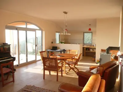 a kitchen and dining room with a table and chairs at Cadre exceptionnel Calme , Nature, Confort in Glavatičići