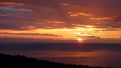 a sunset over the ocean with the sun setting at Cadre exceptionnel Calme , Nature, Confort in Glavatičići