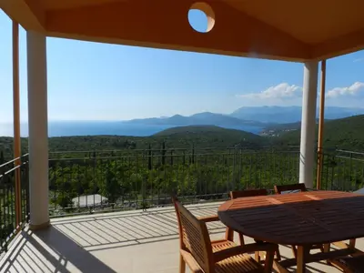 a view from the balcony of a house with a table and chairs at Cadre exceptionnel Calme , Nature, Confort in Glavatičići
