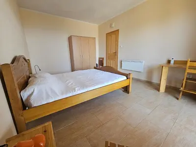 a bedroom with a bed with white sheets and a table at Cadre exceptionnel Calme , Nature, Confort in Glavatičići