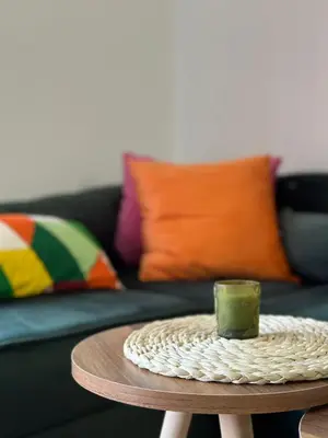 a coffee table with a green candle on top at Apartman AURORA CETINJE in Cetinje