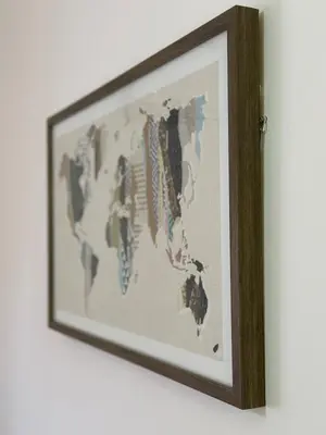 a framed picture of a world map on a wall at Apartman AURORA CETINJE in Cetinje