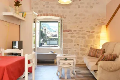 a living room with a couch and a table at Old Town View - Sunny, Bright & Quiet in Kotor