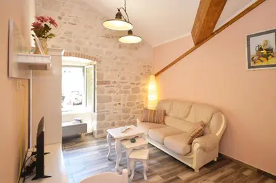 a living room with a couch and a table at Old Town View - Sunny, Bright & Quiet in Kotor