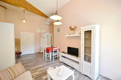 a living room with a tv and a table at Old Town View - Sunny, Bright & Quiet in Kotor