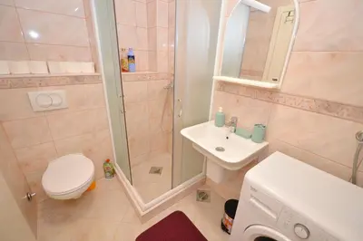 a bathroom with a shower and a toilet and a sink at Old Town View - Sunny, Bright & Quiet in Kotor