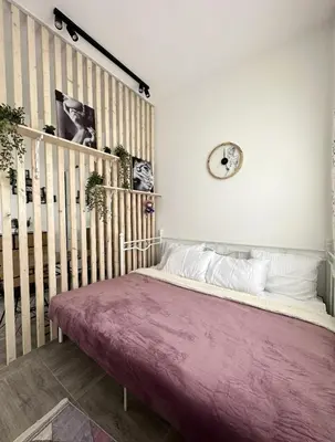 a bedroom with a bed and a clock on the wall at Studio apartment, 5 minutes to the beach in Bar
