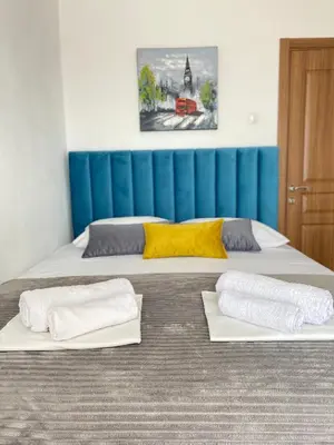 two beds in a room with towels on them at NOA Guest House in Ulcinj