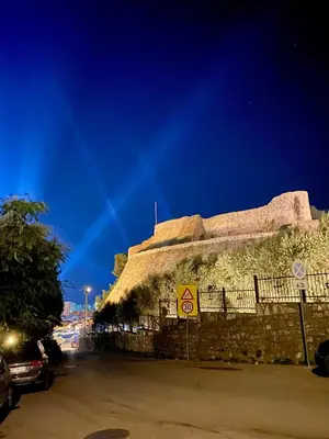 a large stone building with a roof on a street at NOA Guest House in Ulcinj