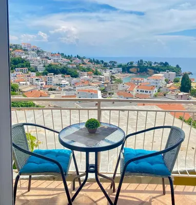 a table and chairs on a balcony with a view at NOA Guest House in Ulcinj