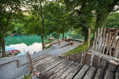 an overhead view of a bench next to a lake at Via river in Podgorica