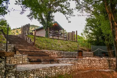 a set of stone stairs leading up to a building at Via river in Podgorica