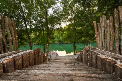 a wooden bridge over a body of water at Via river in Podgorica