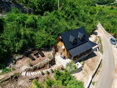 an overhead view of a house with a black roof at Holiday Home MIA in Rijeka Crnojevića