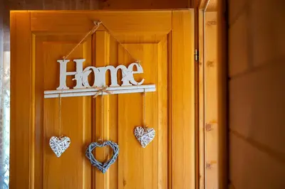 a wooden door with hearts on it with the word fame at Holiday Home MIA in Rijeka Crnojevića