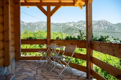a patio with chairs and a table and a view at Holiday Home MIA in Rijeka Crnojevića