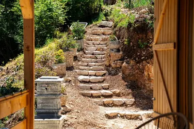 a stone path leading into a garden with a fence at Holiday Home MIA in Rijeka Crnojevića