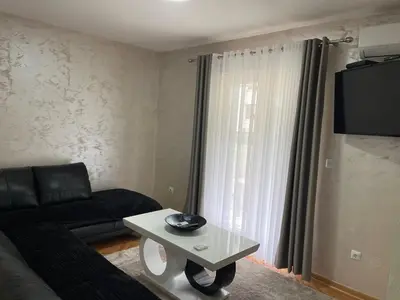 a living room with a couch and a table at Apartment Božović in Budva