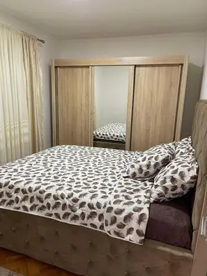 a bedroom with a bed and a large mirror at Apartment Božović in Budva