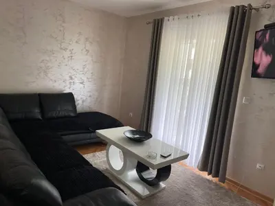 a living room with a couch and a coffee table at Apartment Božović in Budva