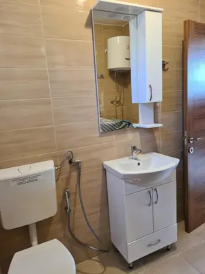 a bathroom with a toilet and a sink and a mirror at KIWI in Bar