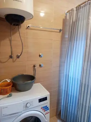 a washing machine with a bowl on top of it at KIWI in Bar