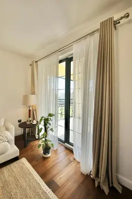 a room with a bed and a window with curtains at Home Filip in Golubovci