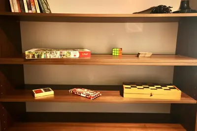 a wooden shelf with books and boxes on it at Home Filip in Golubovci