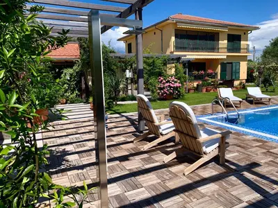 a patio with two chairs and a swimming pool at Home Filip in Golubovci