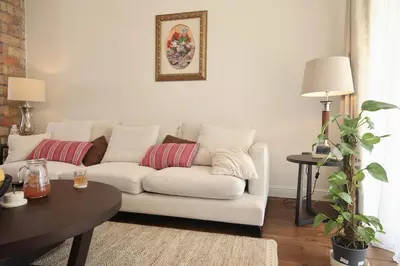 a living room with a white couch and a table at Home Filip in Golubovci