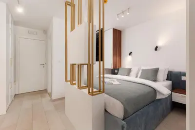 a bedroom with a bed and a mirror at Ocea Studio Apartments in Kotor