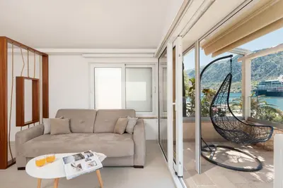 a living room with a couch and a table at Ocea Studio Apartments in Kotor