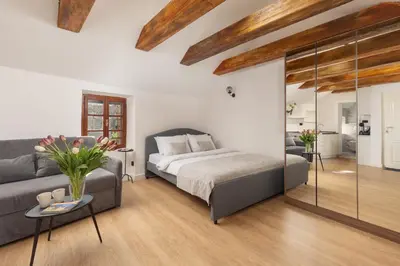 a bedroom with a bed and a couch at Old Town South Gate Apartment in Kotor