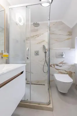 a bathroom with a shower with a toilet and a sink at Old Town South Gate Apartment in Kotor