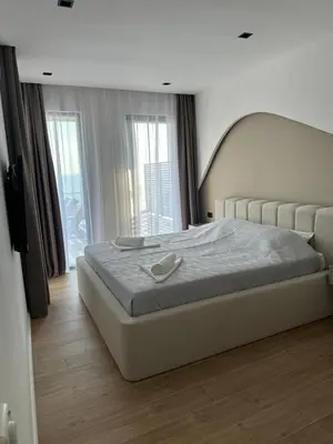 a bedroom with a large bed with a large window at Sunny&calmhouse in Bar