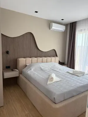 a bedroom with a bed with a hat on it at Sunny&calmhouse in Bar