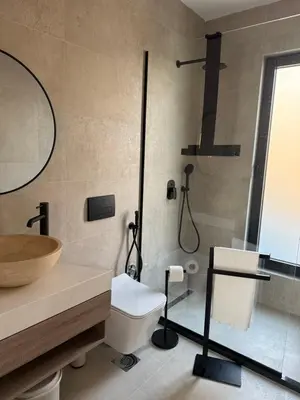 a bathroom with a shower and a toilet and a sink at Sunny&calmhouse in Bar