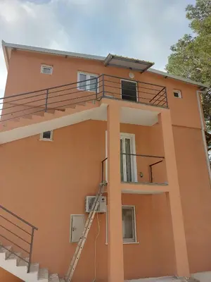 a building with a staircase on the side of it at Crni Bor Sutomore in Sutomore