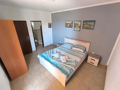 a small bedroom with a bed and a bathroom at Violit Apartments&Restaurant in Sutomore