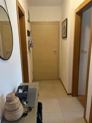 a hallway with a door and a table with a mirror at Apartment with Seaview Zetagradnja in Bar