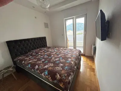 a bedroom with a bed in a room with a window at Apartment with Seaview Zetagradnja in Bar